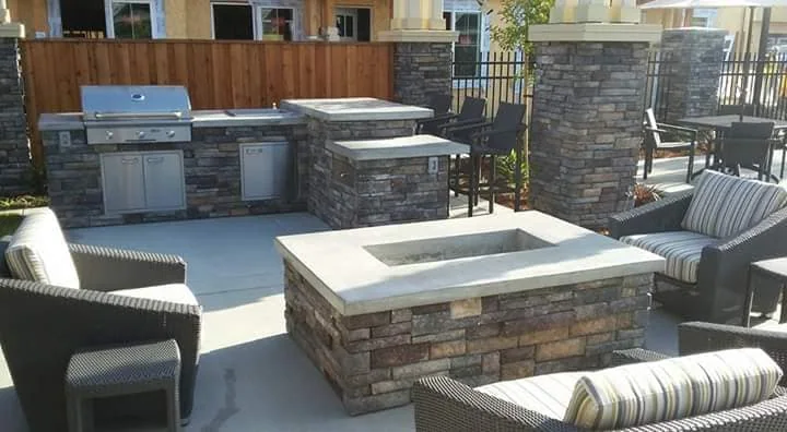 A stone fire pit surrounded by outdoor seating