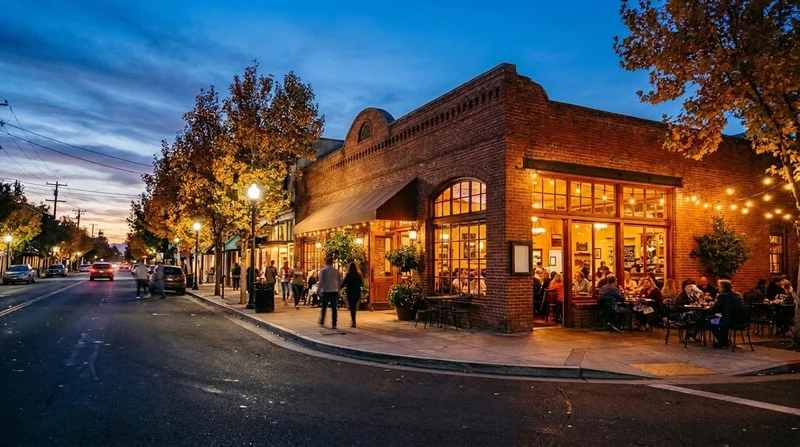 Evening view of a brick-front restaurant along First Street in downtown Livermore with warm string lights