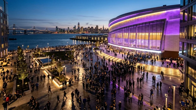 Chase Center waterfront arena in San Francisco Mission Bay illuminated in violet and gold lights at dusk