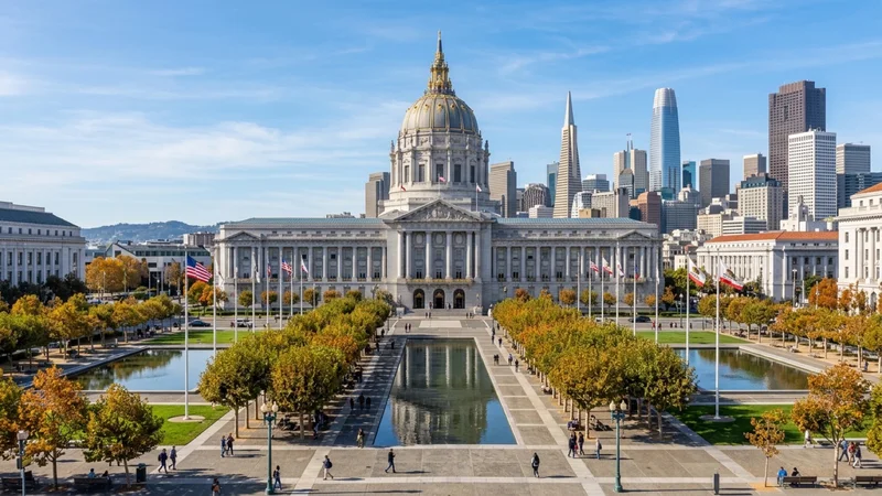 Morning view of San Francisco City Hall’s gilded dome and Civic Center Plaza with downtown skyscrapers rising under a clear autumn sky