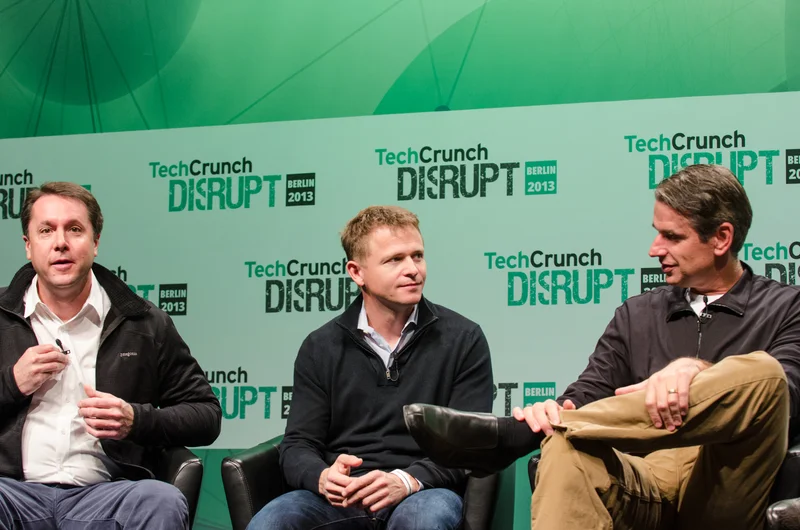 Benchmark partners Mitch Lasky, Peter Fenton, and Bill Gurley speaking on stage during a fireside chat at TechCrunch Disrupt Europe in Berlin.