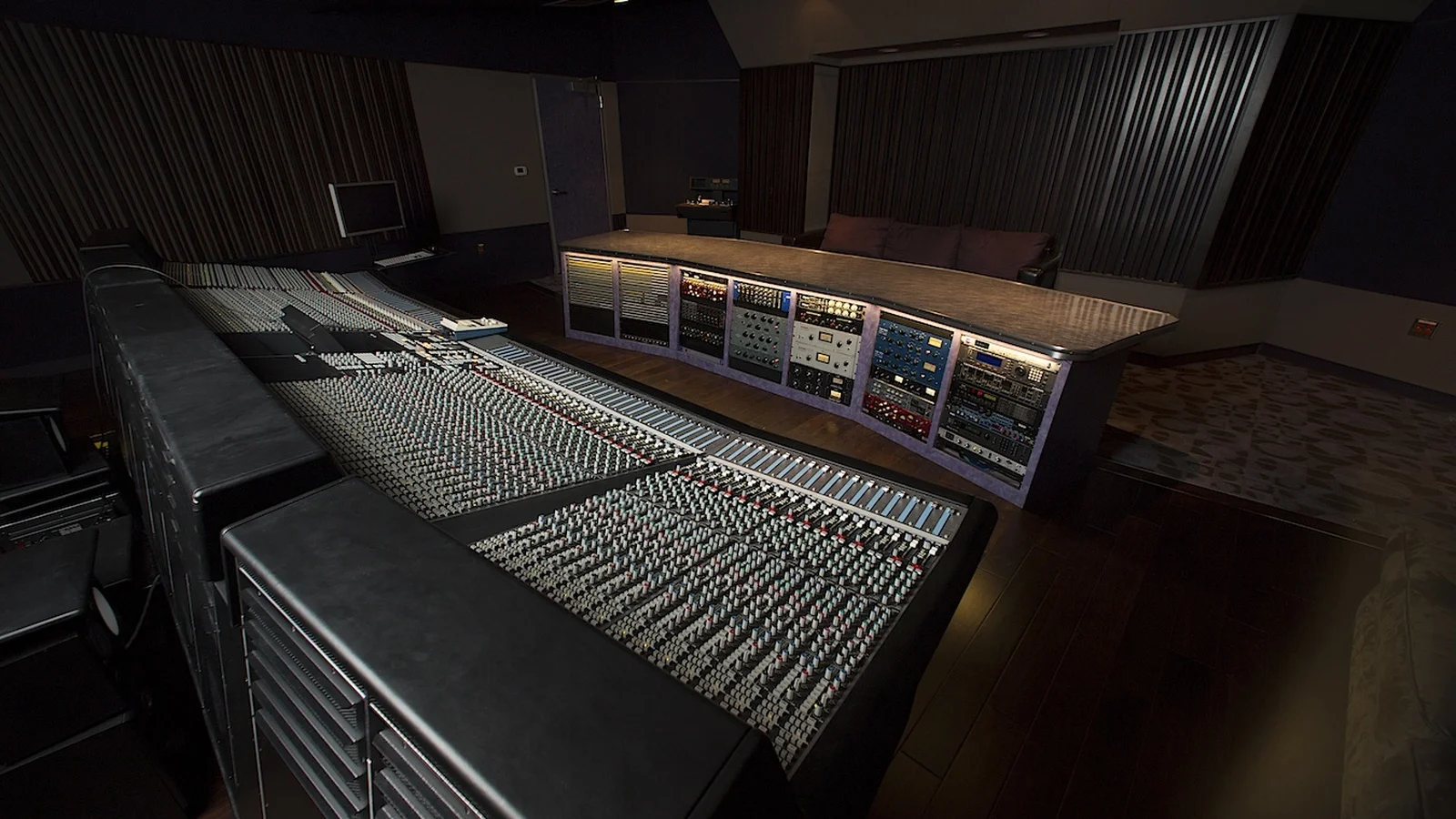 Professional multi-channel audio mixing console and studio workstation representing traditional music production facing synthetic generation standards
